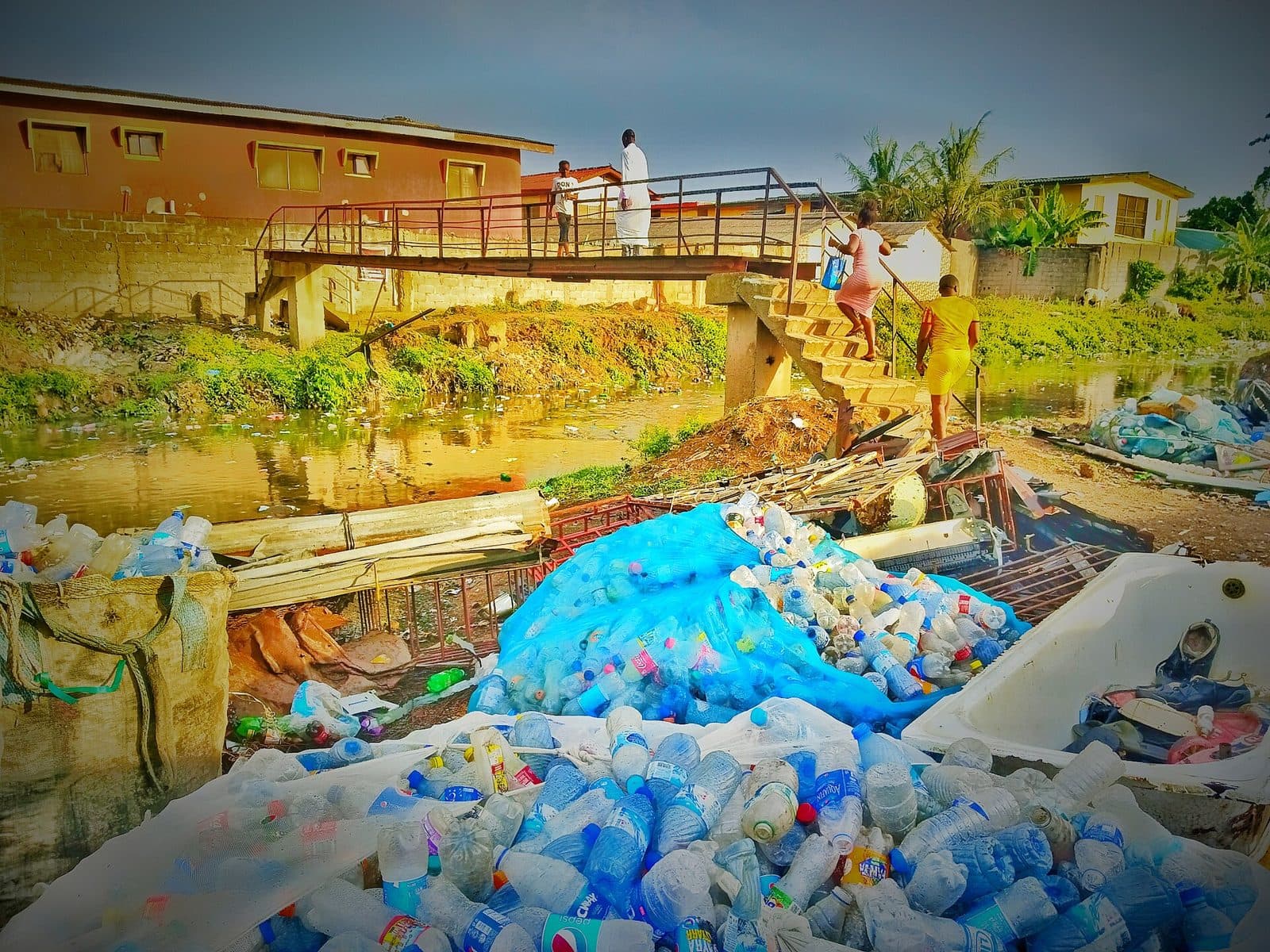Plastic waste piled beside a drainage channel in Ikeja, Lagos